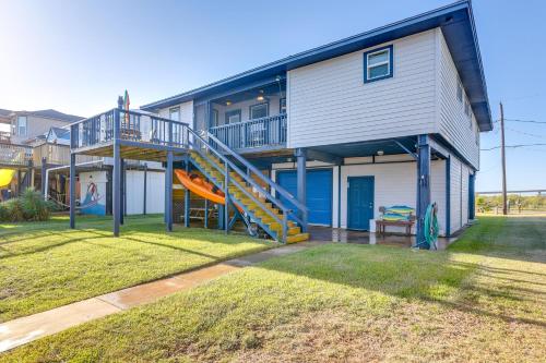 a house with a slide in the yard at Near Ocean Home with Deck and Grill in Surfside Beach in Surfside Beach