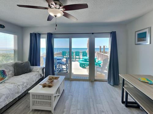 a living room with a couch and a ceiling fan at Haileys Hideaway in Surf City