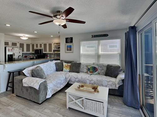 a living room with a couch and a ceiling fan at Haileys Hideaway in Surf City