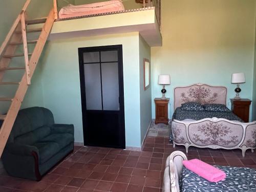 a bedroom with a bed and a staircase with a bunk bed at Demeure Sainte Clotilde, événementiel et chambres d'hôtes à Neffies in Néffiès