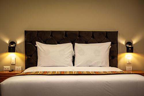 a bedroom with a large bed with a black headboard at Santuario Machupicchu in Machu Picchu