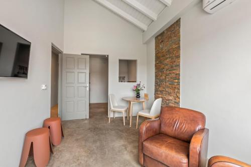 a living room with a chair and a table at PM78 Boutique Apartments in Willemstad
