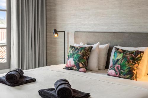 a bedroom with a bed with pillows on it at PM78 Boutique Apartments in Willemstad