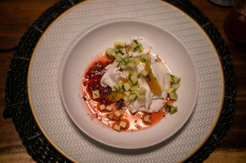 a white plate with food on a table at Divinity Costa Rica All Inclusive Luxury Villa in Dominical
