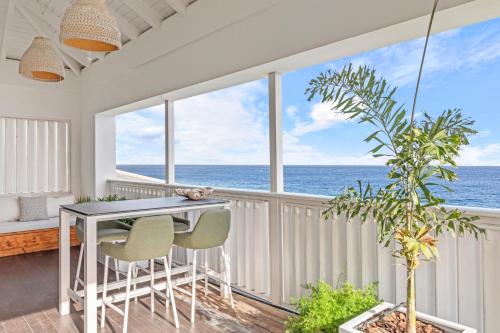 a dining room with a view of the ocean at PM78 Boutique Apartments in Willemstad