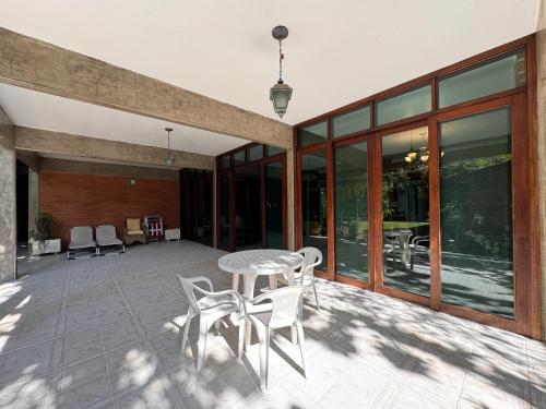 a patio with a table and chairs on it at Casa Una à Beira Rio - Barra do Una - 450m da praia in São Sebastião