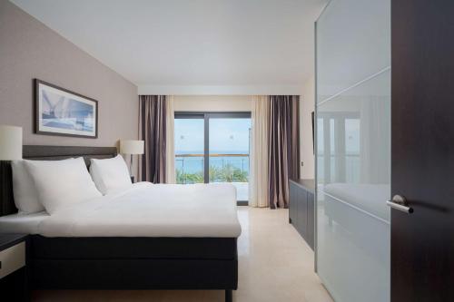 a hotel room with a bed and a window at Radisson Blu Resort Gran Canaria in La Playa de Arguineguín