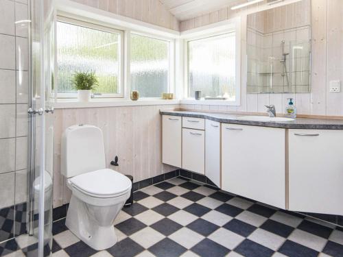 a bathroom with a toilet and a sink at 6 person holiday home in Juelsminde-By Traum in Sønderby