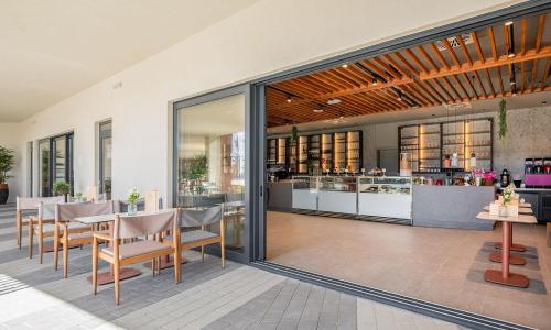 a restaurant with a table and chairs and a counter at Aminess Style Camping Avalona Resort - Pitches in Povljana