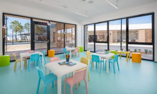 a restaurant with tables and chairs and windows at Aminess Style Camping Avalona Resort - Pitches in Povljana