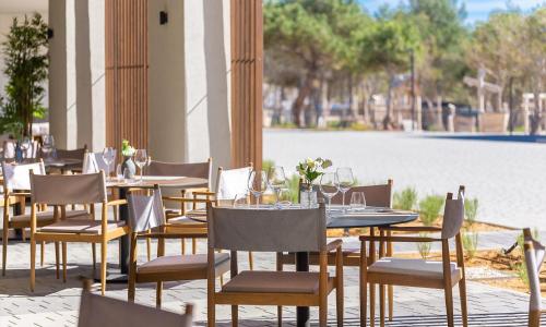a restaurant with tables and chairs and a pool at Aminess Style Camping Avalona Resort - Pitches in Povljana