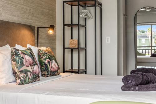 a bedroom with a bed with two stuffed animals on it at PM78 Boutique Apartments in Willemstad