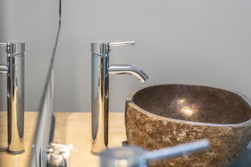 a sink with a faucet in a bathroom at PM78 Boutique Apartments in Willemstad