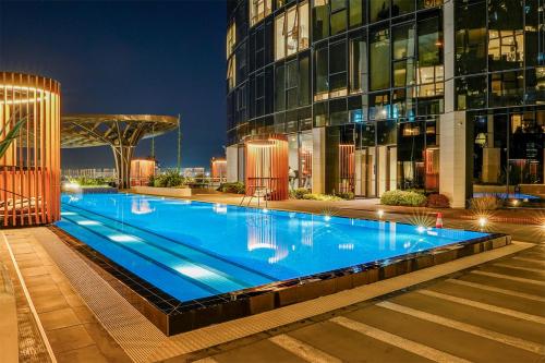 a large swimming pool in front of a building at Tammex Luxury Properties - Melbourne Square in Melbourne