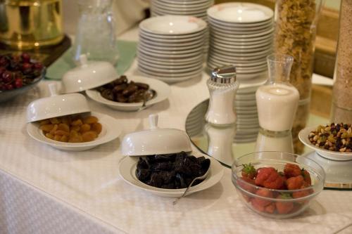a table with plates and bowls of food on it at Hotel Pacific in Ostend