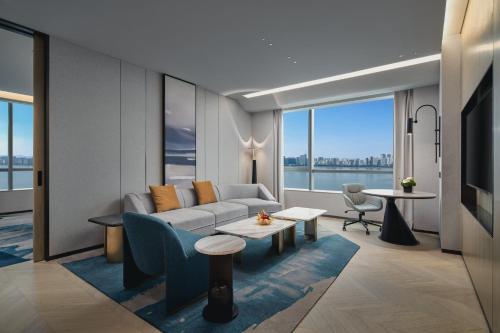 a living room with a couch and a table at Crowne Plaza Hangzhou Riverside by IHG in Hangzhou