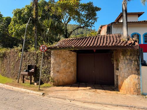 a building with a no parking sign next to a street at Casa Una à Beira Rio - Barra do Una - 450m da praia in São Sebastião