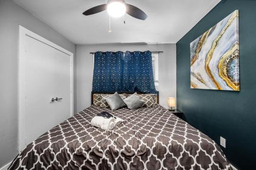 a bedroom with a large bed with blue walls at 1BR Apt with Fully Equipped Kitchen Close to Major Attractions in Houston