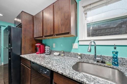 a kitchen with a sink and a refrigerator at 1BR Apt with Fully Equipped Kitchen Close to Major Attractions in Houston