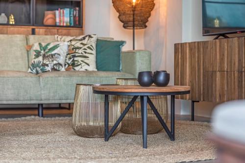 a living room with a coffee table and a couch at PM78 Boutique Apartments in Willemstad