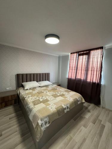 a bedroom with a large bed and a window at Orion Villa 1 in Batumi
