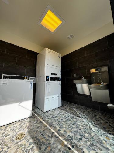 a kitchen with a white refrigerator and a sink at Couples Mirror Cabin- Reflections at Valley Bear Farms Resort in Balsam Grove