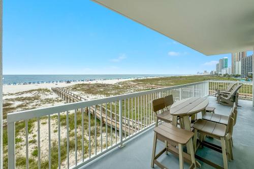 a balcony with a table and chairs and the beach at Perdido Dunes Tower Unit 2W in Orange Beach