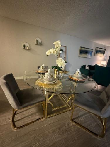 a living room with a glass table and two chairs at Hollywood Apartments Mario & No Themed With Pool FREE parking and WIFI in Los Angeles