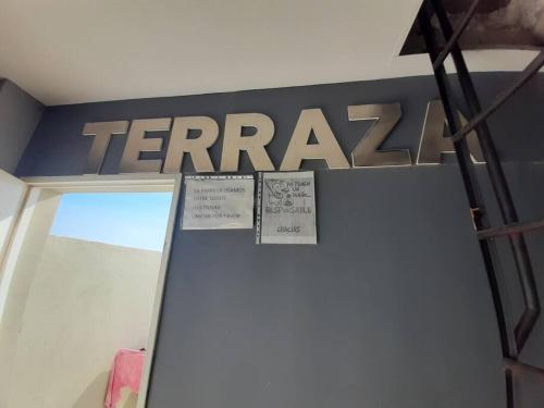 a sign on a wall in a room with atera sign at Apart El Carau in Corrientes