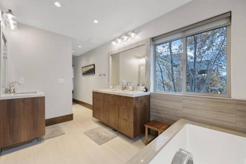 a large bathroom with two sinks and a large window at Heber Hideaway Exquisite Home with Hot Tub in Heber City