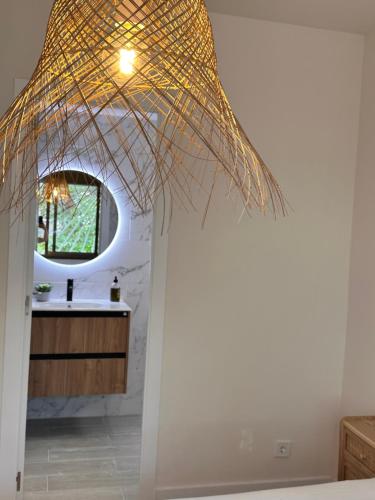 a bathroom with a pendant light and a mirror at Playa Bella Boutique in Calafell