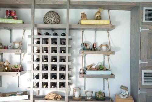 a shelf filled with lots of wine bottles at Caldera's Dolphin Suites in Megalokhori