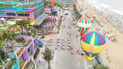 an aerial view of a beach with a bunch of hot air balloons at Flamingo Ibiza Hải Tiến, Căn 2 phòng ngủ view trực diện biển tiêu chuẩn 4NL 2TE in Thanh Hóa