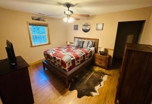 a bedroom with a bed and a ceiling fan at The Barn in Asheville