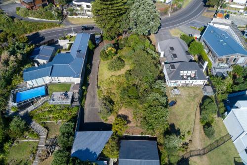 an aerial view of a house with a road at Luxurious Kiwiana Raumati Beachfront Home in Paraparaumu