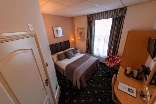 a hotel room with a bed and a window at The Melita in London