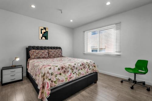 a bedroom with a bed and a green chair at Stylish One-Bedroom Retreat with Central AC & Free Parking in the Heart of Hollywood in Los Angeles