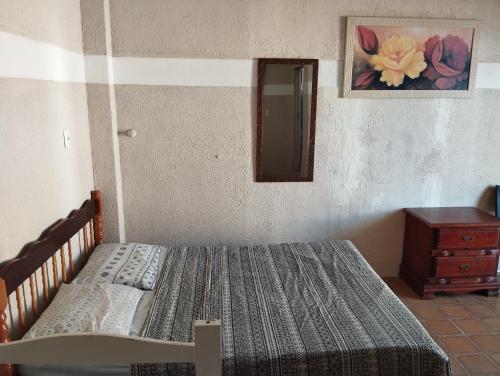 a bedroom with a bed and a dresser at Suite Big Tower in Penha