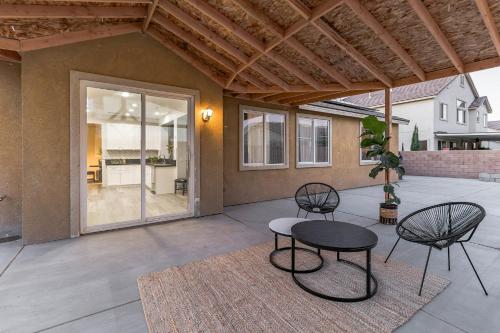 a patio with two chairs and a table on a patio at Modern 4BR Oasis, Fireplace, Patio & Spacious Family Room in Palmdale