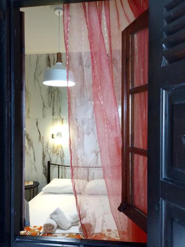 a room with a bed and a red curtain at Villa Zina in Pelion in Agios Dimitrios