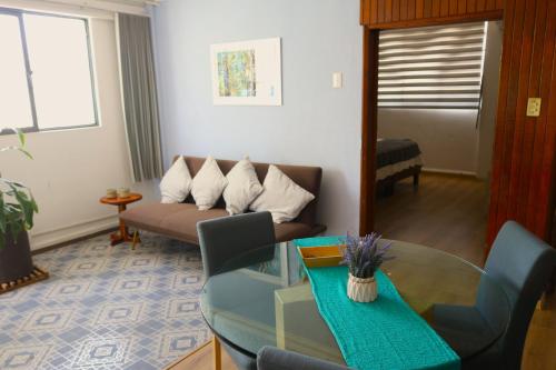a living room with a couch and a glass table at Pino Apartment in Oaxaca City