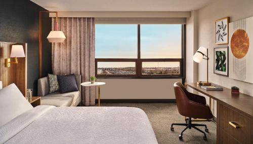 a hotel room with a bed and a couch and a window at Holiday Inn La Verkin - Zion Park by IHG in La Verkin