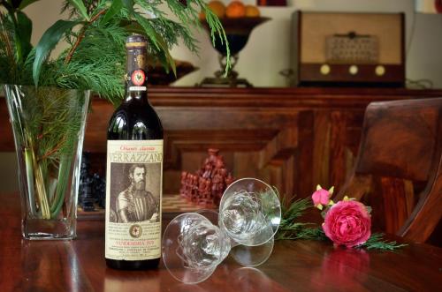 a bottle of wine sitting on a table with glasses at Melinas Boutique Hotel B&B in Kipoi