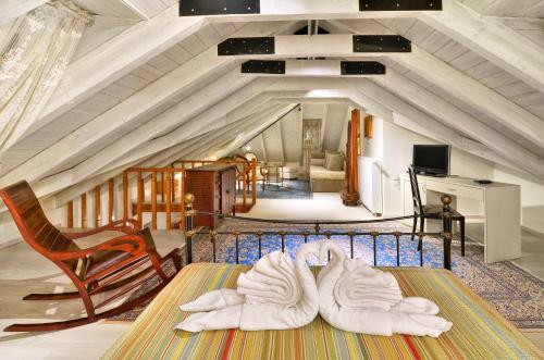 a room with white towels on a table in a attic at Melinas Boutique Hotel B&B in Kipoi