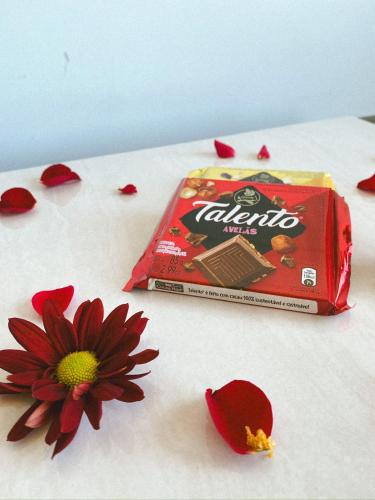 a bag of chips sitting on a table next to a flower at The Eco Palace Hostel in Búzios