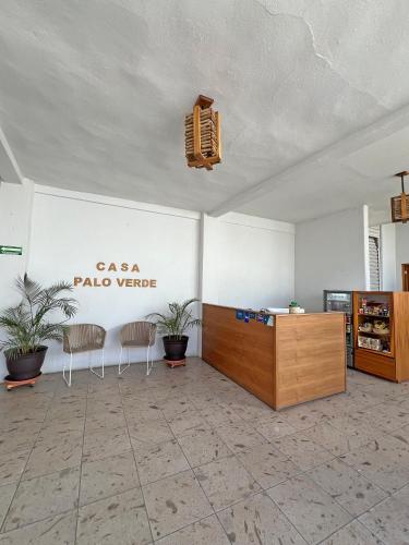 a room with chairs and a table and a sign at Casa Palo Verde in Cabo San Lucas