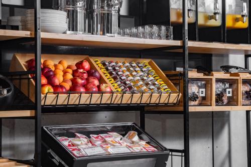 a shelf filled with different types of fruits and snacks at Travelodge Hotel Hurstville Sydney in Sydney