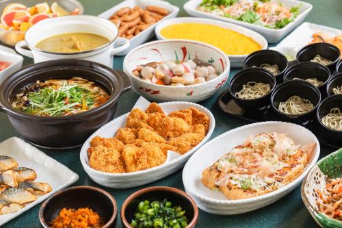 a table topped with bowls of different types of food at Hotel Sunroute Niigata in Niigata