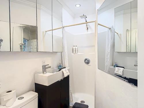 a white bathroom with a sink and a mirror at 7 Room TampaGolfVillas by AmericanVacationliving in Wesley Chapel