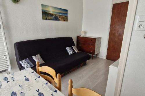 a small living room with a couch and a table at Studio 30m plage - Marina 5 - 31 allée des pinons - 1-1 in Saint-Jean-de-Monts